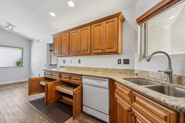 kitchen with visible vents, dishwasher, lofted ceiling, wood finished floors, and a sink