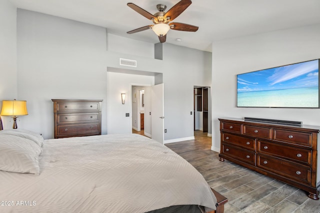 bedroom featuring dark wood-type flooring, visible vents, ceiling fan, and baseboards