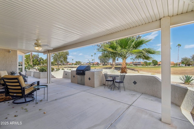 view of patio with ceiling fan, an outdoor kitchen, and grilling area