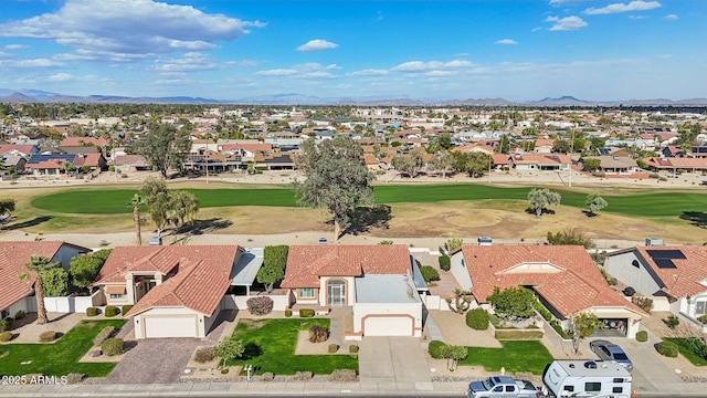 drone / aerial view with a residential view, a mountain view, and golf course view