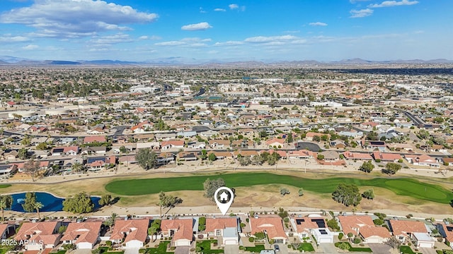 drone / aerial view featuring a residential view, view of golf course, and a mountain view