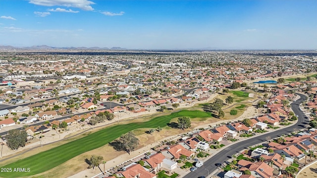 birds eye view of property with a mountain view, view of golf course, and a residential view