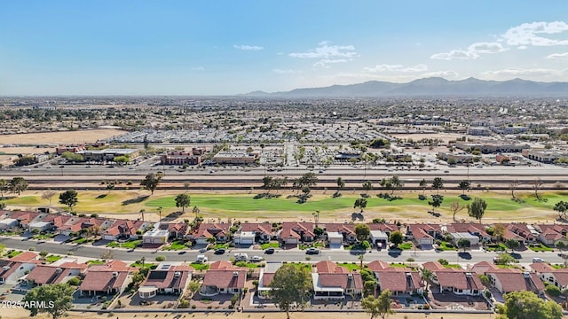 drone / aerial view with a residential view, a mountain view, and golf course view