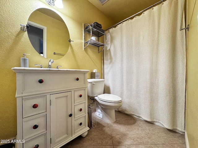 bathroom with vanity, tile patterned flooring, and toilet