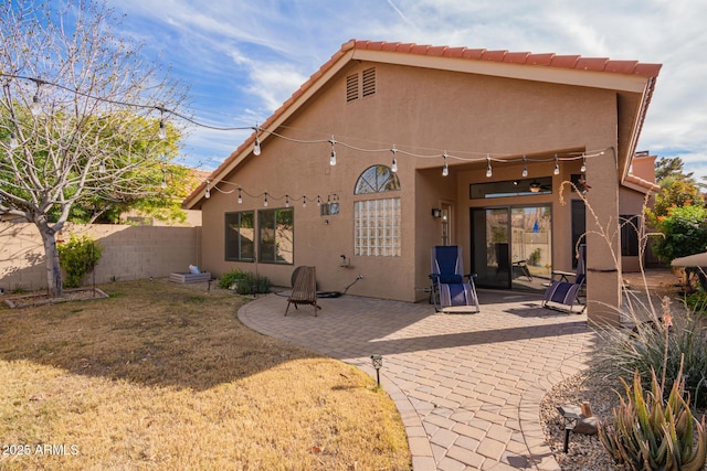 rear view of property with a lawn and a patio