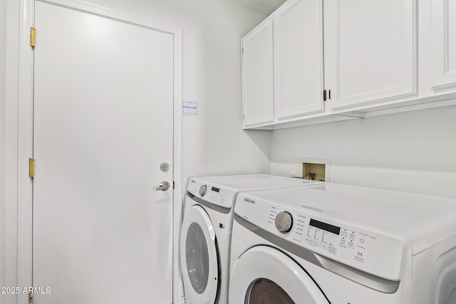 laundry area with cabinets and washing machine and clothes dryer