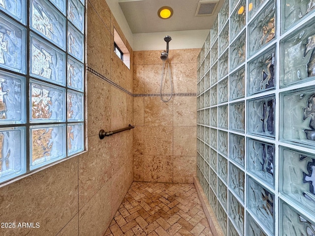 bathroom with tiled shower