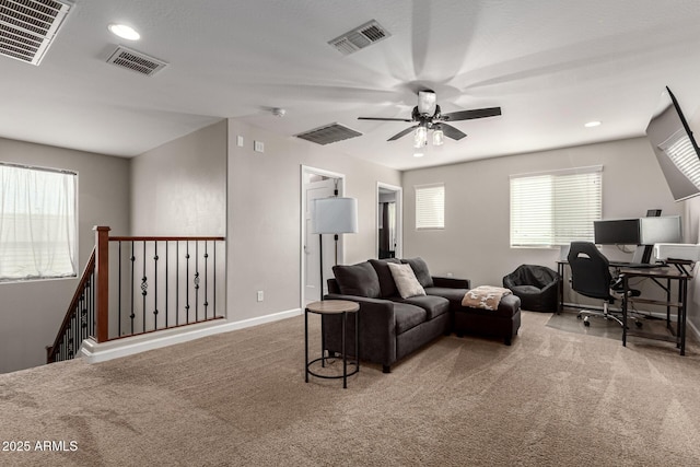 carpeted living room featuring ceiling fan