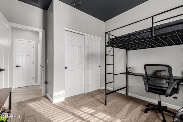 carpeted bedroom featuring a closet