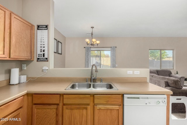 kitchen featuring a healthy amount of sunlight, white dishwasher, open floor plan, and a sink