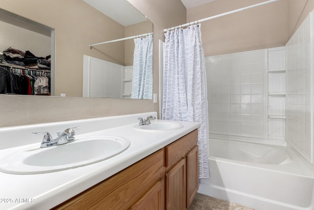 bathroom with double vanity, shower / bath combo, a sink, and tile patterned floors