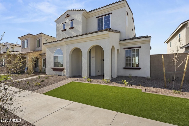 mediterranean / spanish-style house featuring a front lawn