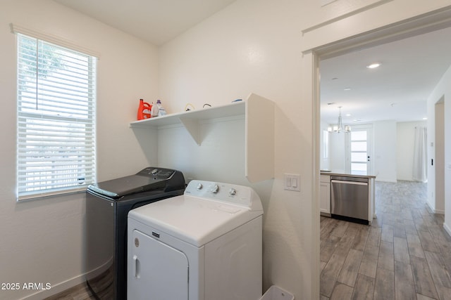300 N Gila Springs Blvd Unit 144, Chandler, AZ 85226 - washroom featuring washer and clothes dryer, light wood finished floors, baseboards, and a chandelier