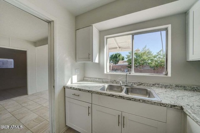 kitchen with a sink and white cabinets