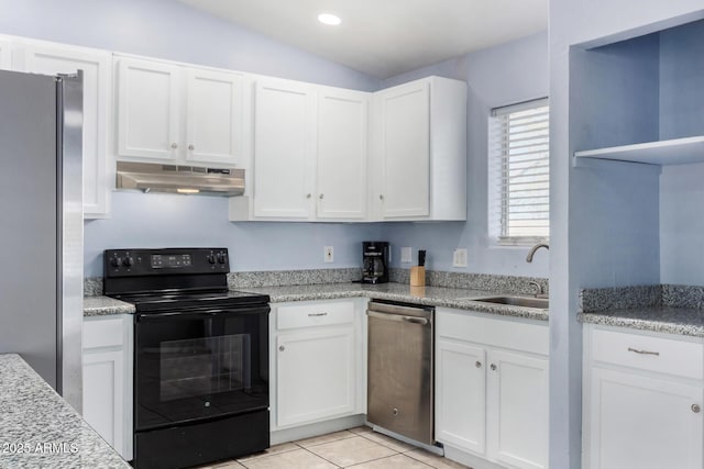 kitchen featuring light tile patterned floors, appliances with stainless steel finishes, sink, and white cabinets