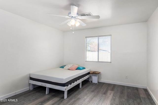 bedroom with dark hardwood / wood-style floors and ceiling fan