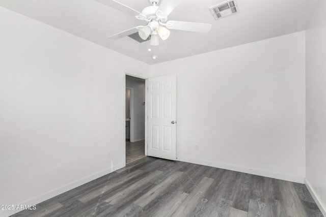 empty room featuring dark hardwood / wood-style flooring and ceiling fan