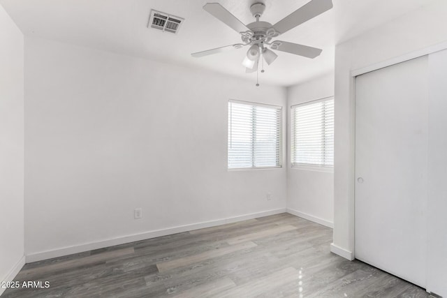 unfurnished bedroom with a closet, ceiling fan, and light wood-type flooring