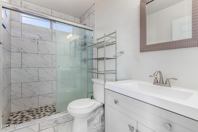 bathroom with vanity, toilet, and a shower with shower door