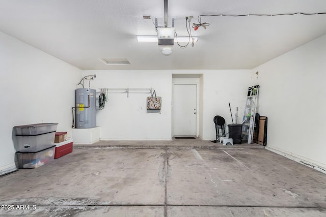 garage with a garage door opener and electric water heater