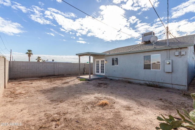 rear view of property featuring a patio and french doors