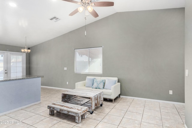 sitting room with ceiling fan with notable chandelier, light tile patterned floors, and high vaulted ceiling