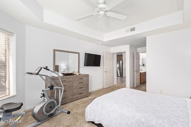 14000 N 94th St N Unit 1129, Scottsdale, AZ 85260 - bedroom featuring freestanding refrigerator, carpet, a raised ceiling, and multiple windows