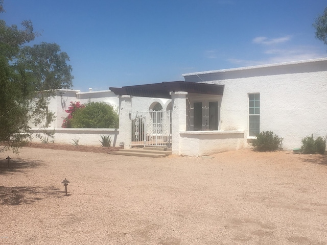 back of house featuring stucco siding