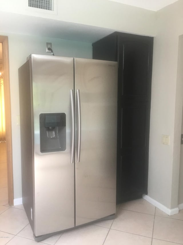 interior space featuring baseboards, visible vents, and stainless steel fridge with ice dispenser