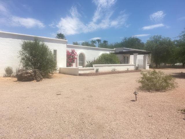 rear view of house with stucco siding