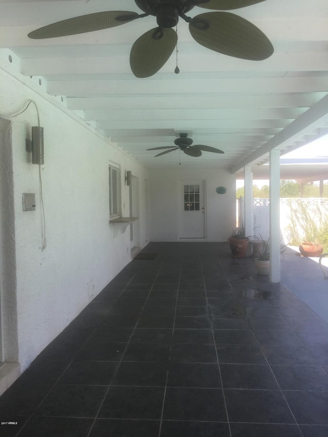 view of patio / terrace with ceiling fan and fence