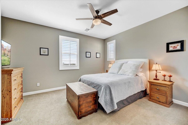 bedroom with baseboards, ceiling fan, visible vents, and light colored carpet