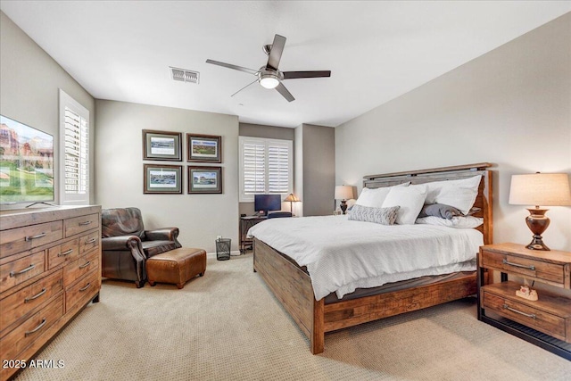 bedroom featuring light carpet, multiple windows, visible vents, and ceiling fan