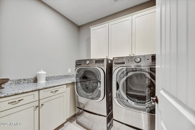 laundry room with cabinet space and washer and dryer