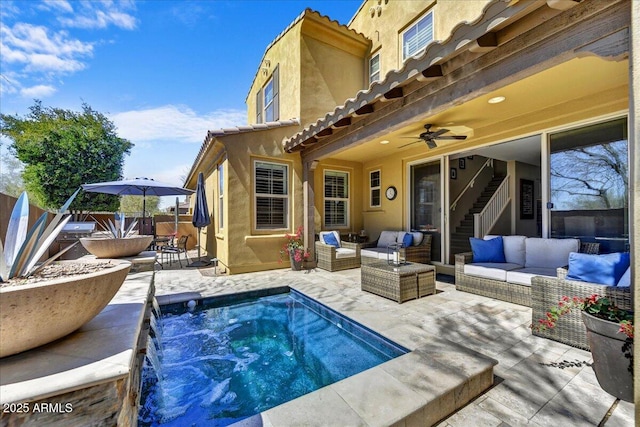view of swimming pool featuring an outdoor hangout area, fence, a ceiling fan, and a patio area