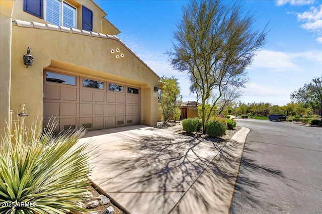 garage featuring concrete driveway