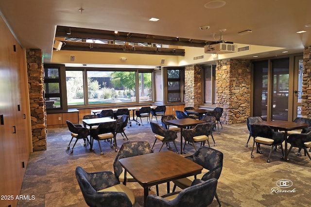 dining room featuring stone finish floor and visible vents