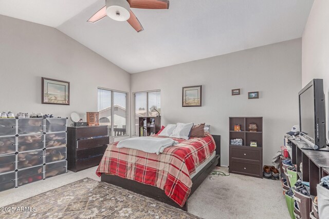 bedroom with ceiling fan, carpet flooring, and lofted ceiling