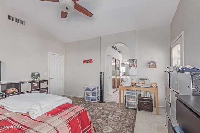bedroom with carpet floors, arched walkways, baseboards, vaulted ceiling, and visible vents