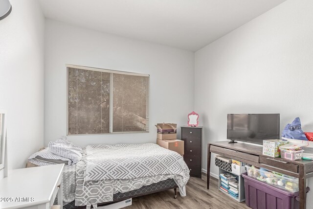 bedroom featuring wood finished floors