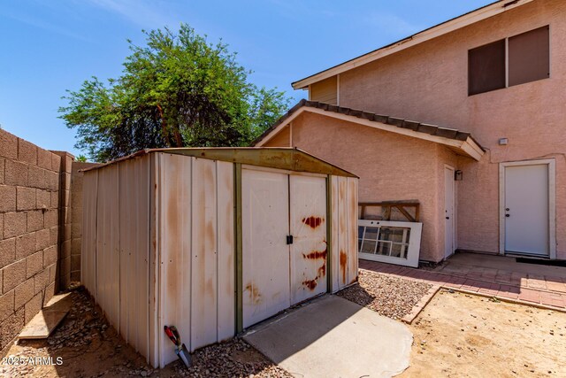 view of shed with fence