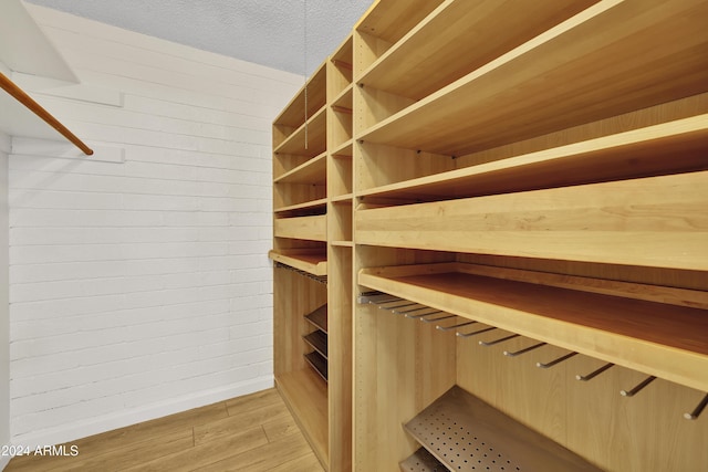 spacious closet with light hardwood / wood-style floors