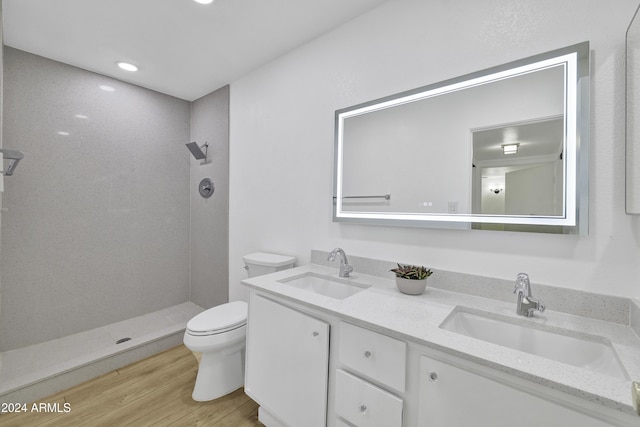 bathroom featuring walk in shower, hardwood / wood-style floors, vanity, and toilet