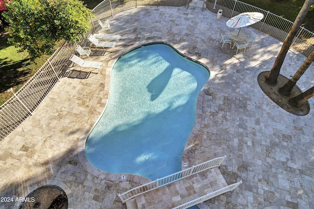 view of swimming pool featuring a patio