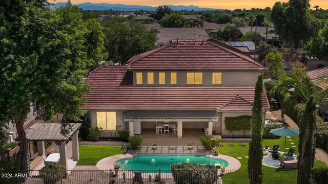 view of front of property with a patio, a gazebo, and a fenced in pool