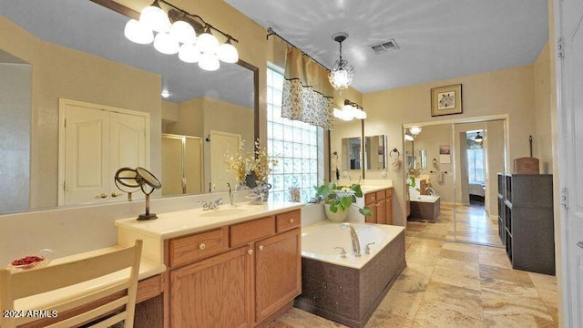 bathroom featuring a bathtub, double sink vanity, tile patterned floors, and a chandelier