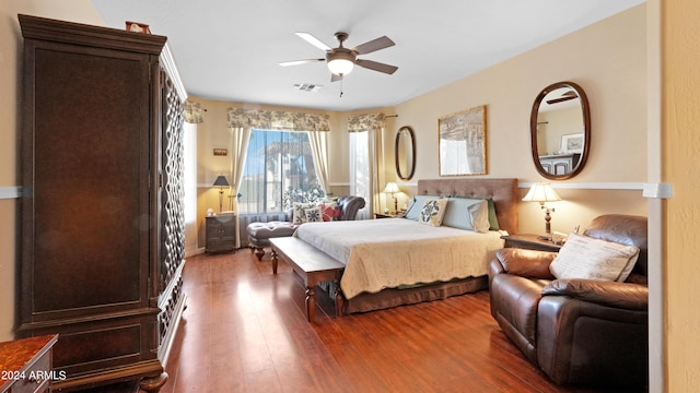 bedroom with visible vents, a ceiling fan, and wood finished floors