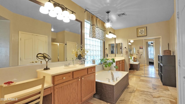 full bathroom featuring visible vents, two vanities, a stall shower, a bath, and a sink