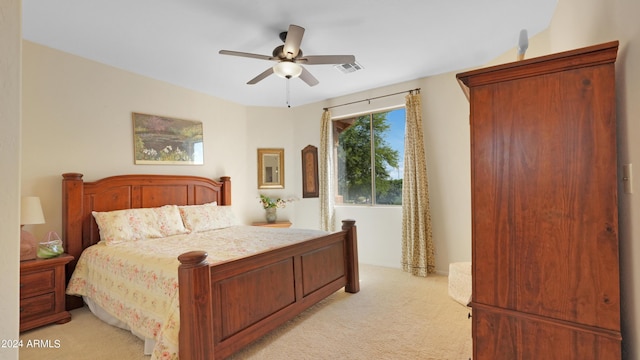 bedroom with a ceiling fan, light colored carpet, and visible vents