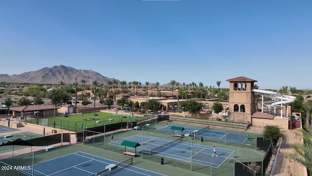 view of sport court featuring fence and a mountain view